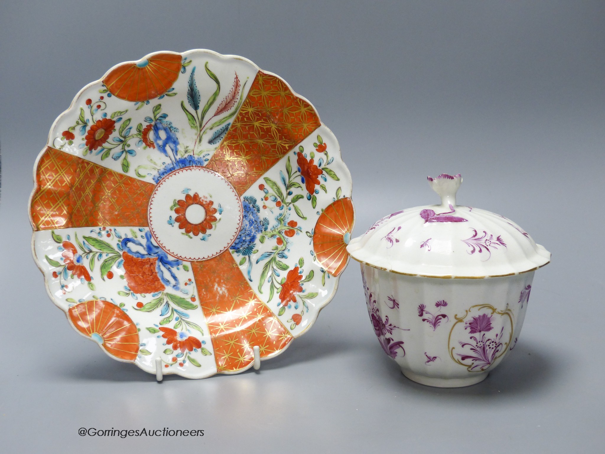 A Worcester plate painted with a very rare Scarlet Japan pattern with blue rock, diameter 20cm, and a Worcester sucrier and cover in a puce Meissen style pattern